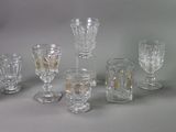 a lot of glasses that are sitting on a table
