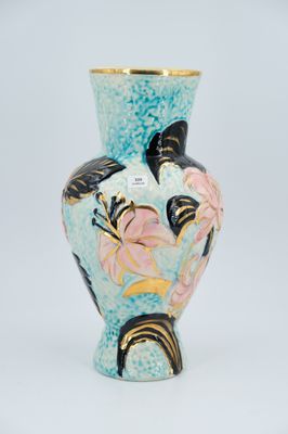 a blue vase with flowers and butterflies on it on a white surface