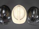 three hard hats are lined up on top of each other