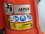 a red fire hydrant with various stickers on it