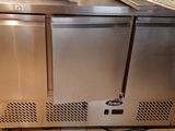 a stainless steel counter with a computer on top of it