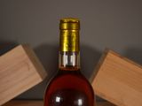 a bottle of wine sitting on a table next to a block of wood