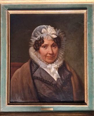 portrait of a woman in a bonnet and a brown coat in a green frame
