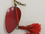 a red fishing hook with a red fish hook attached to it