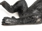 a statue of a man laying down on his stomach