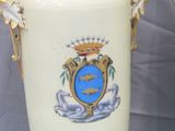 two vases that have been decorated with a coat of arms on them