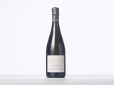 a bottle of wine sitting on top of a white table