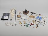 an assortment of religious items including a rosary, a book, and other items