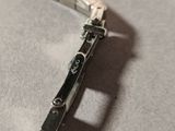 a silver watch that is laying on a table