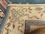 an image of a rug on a wooden floor with a blue background