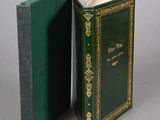 a green book opened to reveal a green cover