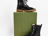 black leather boots with laces and a box on a white background