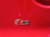 a red car with a fork on it ' s hood