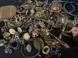 a pile of assorted jewelry on a black table
