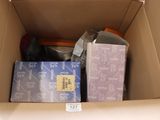 a cardboard box filled with assorted items in it