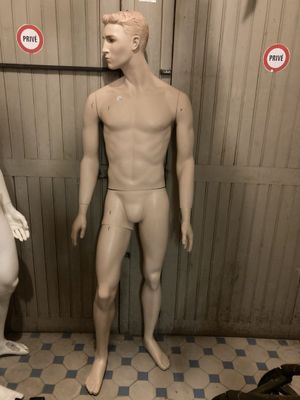 two mannequins standing next to each other in a room