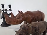 two rhinos and a rhino figurine sitting on a table