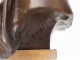 bronze sculpture of a horse head on a wooden base