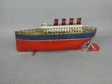 a model of a boat on a stand on a white surface