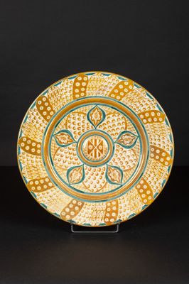 an orange and blue plate with a design on it