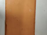 an orange piece of paper hanging on a wall in a room