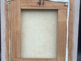 an old picture frame with a picture of a cross on it
