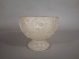 a white glass bowl sitting on top of a table