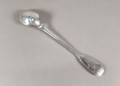 une cuillère en argent avec un manche de cuillère sur une table