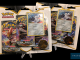 three packs of pokemon trading cards on display in a store