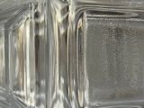a close up of a glass block with water on it