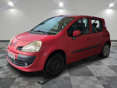 a picture of a small red car parked in a garage