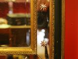a mirror hanging on a red wall in a room