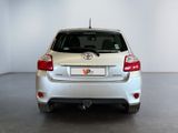 a white toyota yaris parked in a white room