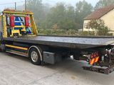 a flat bed truck with a flat bed on the back of it