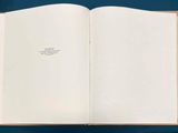 an open book on a table with a pen and paper
