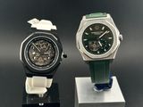 two watches are sitting on a stand on a black surface