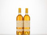 two bottles of wine sitting on top of a table next to each other