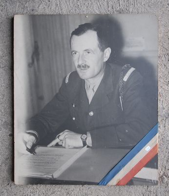 black and white photograph of a man in uniform sitting at a desk