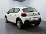 the rear of a white citrole car parked in a garage