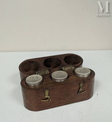 a small wooden box with four jars in it