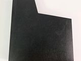 a black piece of paper on a white surface