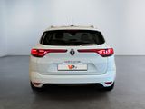 the rear end of a white car in a white room
