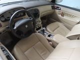 beige interior of a car with leather seats and steering wheel