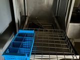 a blue basket that is sitting on a rack in a kitchen