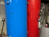 two blue and red water tanks sitting next to each other