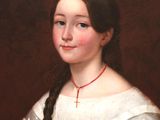 portrait of a young girl in a white dress with braids and a red necklace