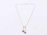 a necklace with a silver chain and two pink beads on a white background