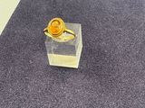 a yellow ring sitting on top of a clear box