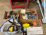 many boxes of tools sitting on the floor in the garage