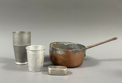 three cups, a saucepan, a spoon and a cup on a table